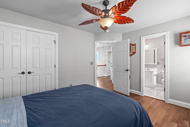 321 Commons Walk Cir, Cary, NC 27519 - bedroom featuring wood finished floors, baseboards, ceiling fan, and ensuite bath