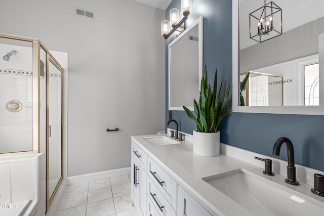 321 Commons Walk Cir, Cary, NC 27519 - full bath with marble look tile flooring, a shower stall, a chandelier, baseboards, and double vanity