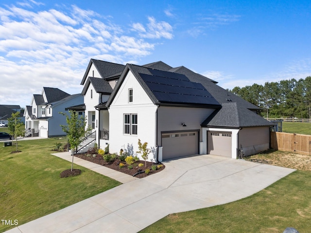 105 Scotland Dr, Youngsville, NC 27596 - view of front of home featuring a shingled roof, solar panels, concrete driveway, and a garage