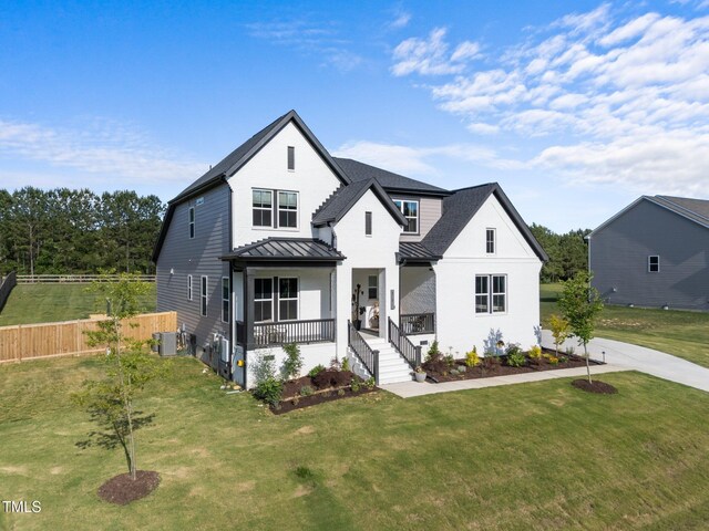 105 Scotland Dr, Youngsville, NC 27596 - modern farmhouse style home with a standing seam roof, a porch, metal roof, central air condition unit, and a shingled roof