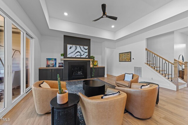105 Scotland Dr, Youngsville, NC 27596 - living area featuring light wood-type flooring, stairway, a glass covered fireplace, a ceiling fan, and recessed lighting
