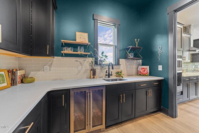 105 Scotland Dr, Youngsville, NC 27596 - kitchen with wine cooler, a sink, light wood-type flooring, decorative backsplash, and light countertops