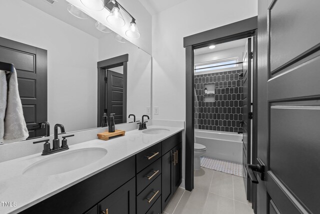 105 Scotland Dr, Youngsville, NC 27596 - bathroom featuring double vanity, toilet, tile patterned floors, and bathtub / shower combination