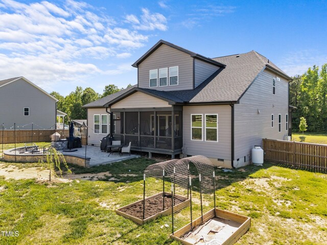 105 Scotland Dr, Youngsville, NC 27596 - rear view of property with a vegetable garden, a sunroom, a patio area, a shingled roof, and an outdoor fire pit