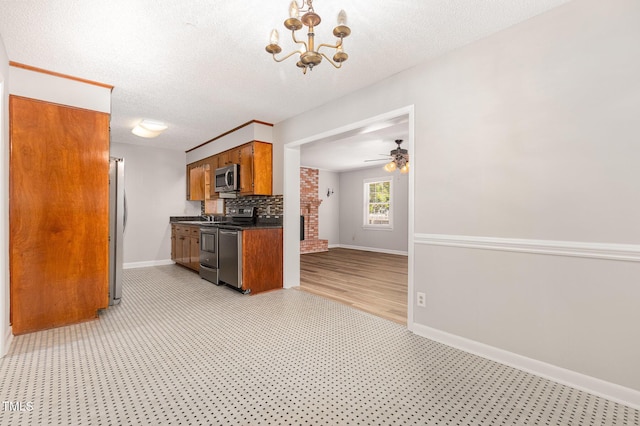 1304 Park Ave, Dunn, NC 28334 - kitchen with appliances with stainless steel finishes, dark countertops, brown cabinets, baseboards, and a textured ceiling
