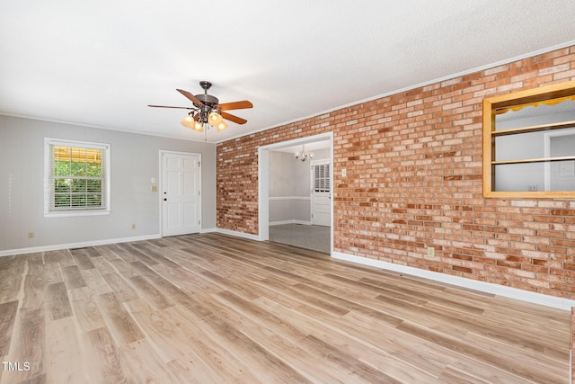 1304 Park Ave, Dunn, NC 28334 - unfurnished room with brick wall, a chandelier, ceiling fan, wood finished floors, and ornamental molding