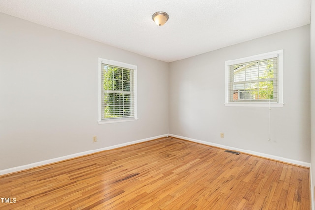 1304 Park Ave, Dunn, NC 28334 - spare room featuring light wood-type flooring and baseboards