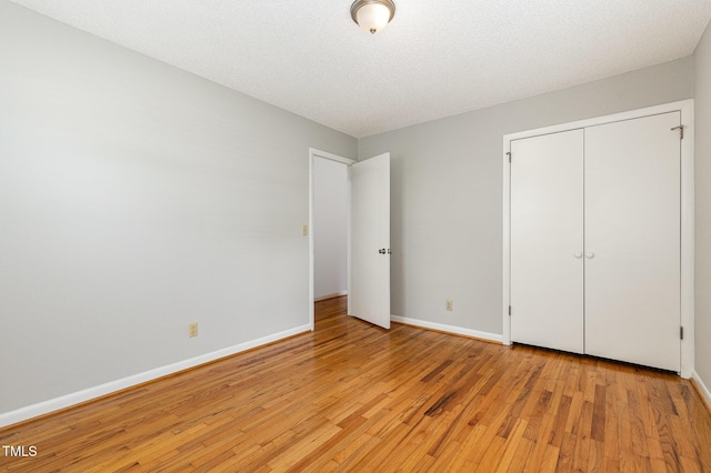 1304 Park Ave, Dunn, NC 28334 - unfurnished bedroom featuring light wood-style floors, baseboards, and a closet