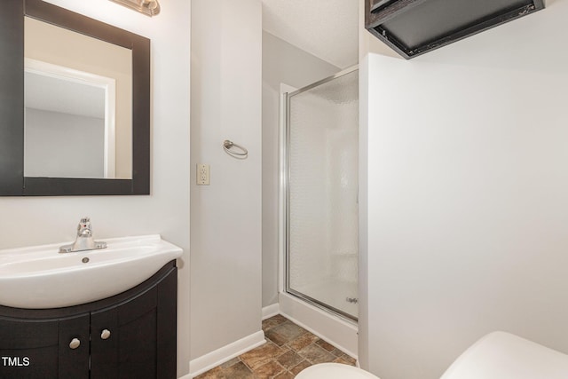 1304 Park Ave, Dunn, NC 28334 - bathroom featuring toilet, a shower stall, stone finish floors, and vanity