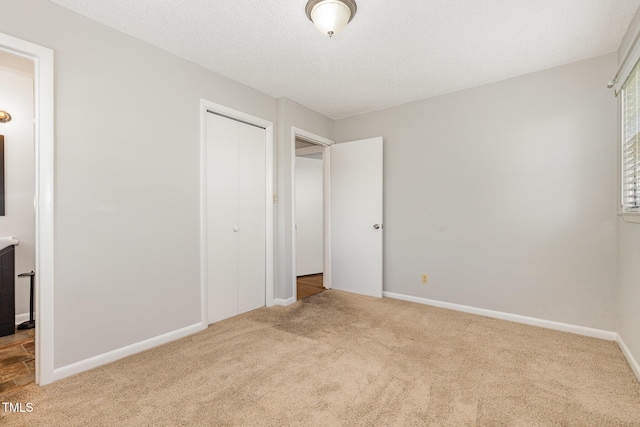 1304 Park Ave, Dunn, NC 28334 - unfurnished bedroom featuring carpet, a closet, and baseboards