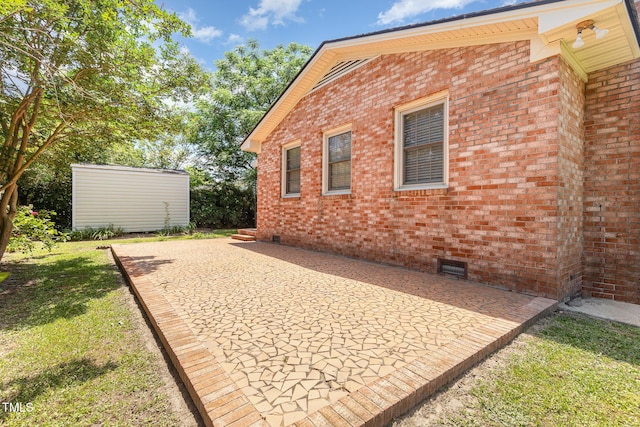 1304 Park Ave, Dunn, NC 28334 - view of property exterior with crawl space, brick siding, a patio area, and a yard