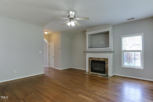 1310 Southgate Dr, Raleigh, NC 27610 - unfurnished living room featuring a premium fireplace, wood finished floors, ceiling fan, and baseboards