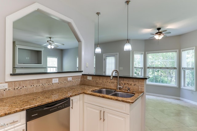 1310 Southgate Dr, Raleigh, NC 27610 - kitchen featuring stainless steel dishwasher, a ceiling fan, a sink, and backsplash