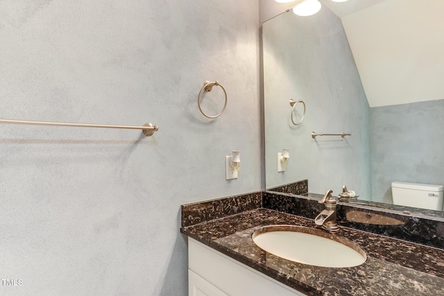 1310 Southgate Dr, Raleigh, NC 27610 - half bath featuring vanity, toilet, and vaulted ceiling