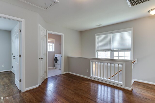 1310 Southgate Dr, Raleigh, NC 27610 - laundry area featuring washer / dryer, wood finished floors, baseboards, and attic access