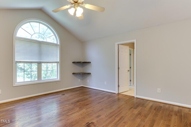 1310 Southgate Dr, Raleigh, NC 27610 - empty room featuring wood finished floors, vaulted ceiling, ceiling fan, and baseboards