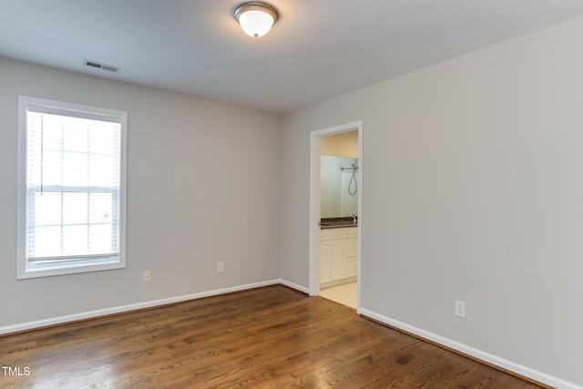 1310 Southgate Dr, Raleigh, NC 27610 - unfurnished room with plenty of natural light, baseboards, and wood finished floors