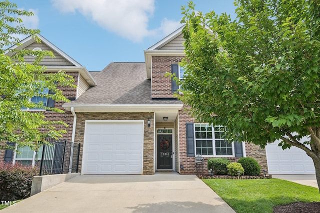 1004 Lake Michael Way, Mebane, NC 27302 - view of front of house featuring driveway, a shingled roof, a garage, brick siding, and stone siding