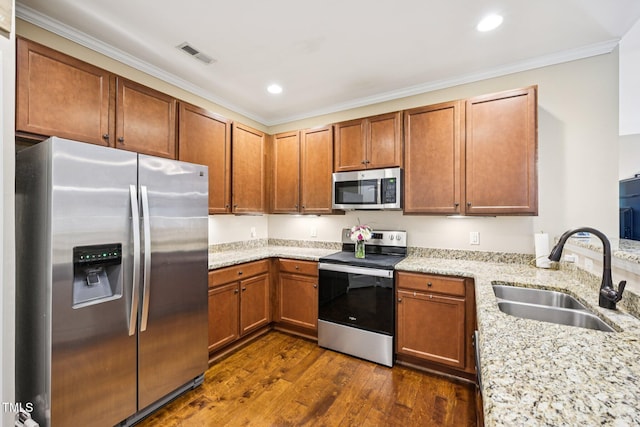 1004 Lake Michael Way, Mebane, NC 27302 - kitchen featuring stainless steel appliances, a sink, ornamental molding, light stone counters, and dark wood finished floors