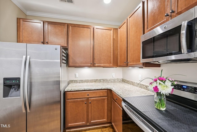 1004 Lake Michael Way, Mebane, NC 27302 - kitchen with stainless steel appliances, crown molding, brown cabinetry, and light stone counters