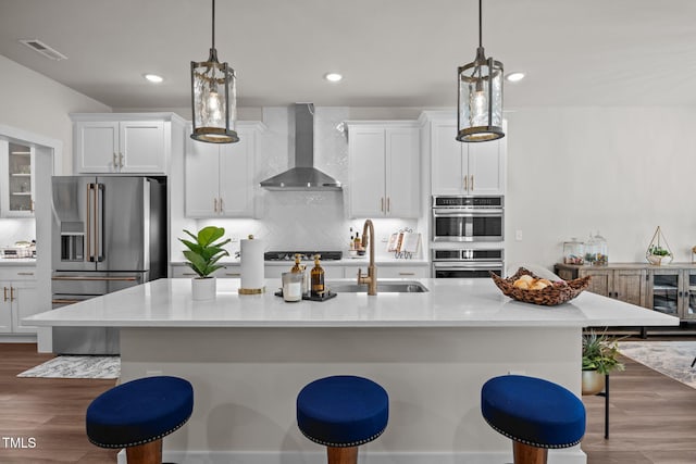 232 Duncan Creek Rd, Lillington, NC 27546 - kitchen with wall chimney range hood, stainless steel appliances, decorative backsplash, dark wood-style flooring, and recessed lighting