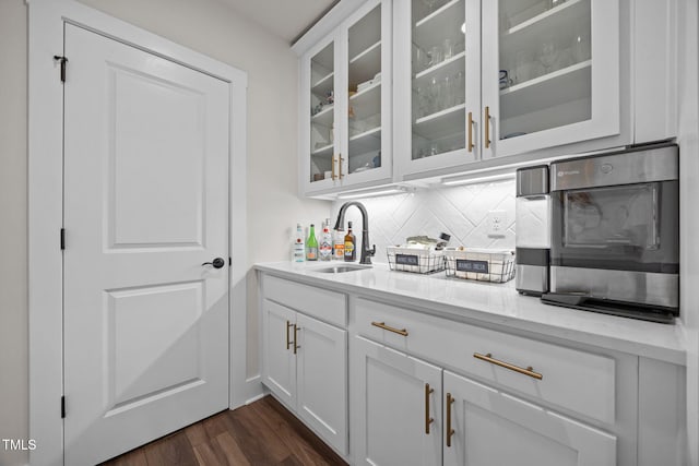 232 Duncan Creek Rd, Lillington, NC 27546 - bar with decorative backsplash, dark wood-style floors, and stainless steel microwave