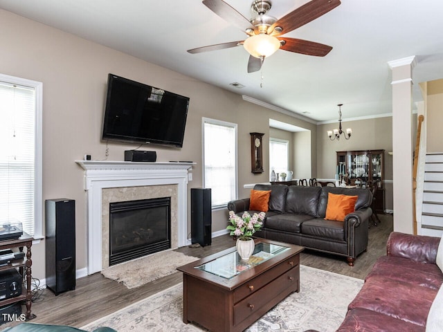 8001 Strawberry Meadows St, Raleigh, NC 27613 - living area with wood finished floors, a premium fireplace, a ceiling fan, a chandelier, and ornamental molding