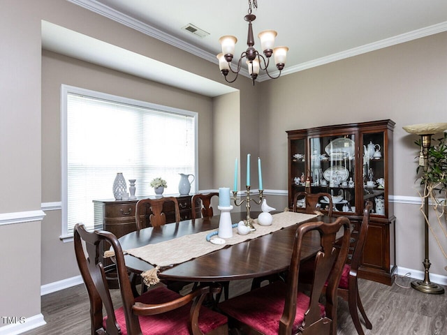 8001 Strawberry Meadows St, Raleigh, NC 27613 - dining area with wood finished floors, a chandelier, healthy amount of natural light, and ornamental molding