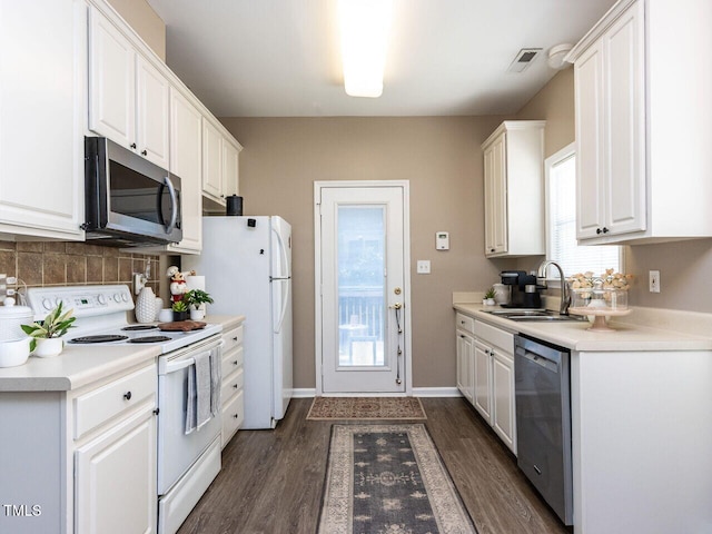 8001 Strawberry Meadows St, Raleigh, NC 27613 - kitchen featuring stainless steel appliances, white cabinetry, dark wood-type flooring, and decorative backsplash