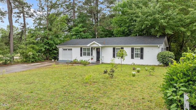 3803 Jonesville Rd, Wake Forest, NC 27587 - ranch-style house featuring asphalt driveway, an attached garage, a front yard, and view of scattered trees