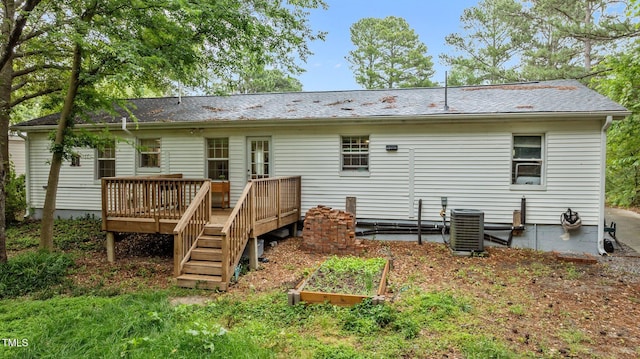 3803 Jonesville Rd, Wake Forest, NC 27587 - back of property with a wooden deck, central AC unit, a patio area, and a vegetable garden