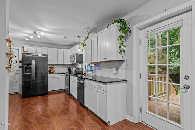 3803 Jonesville Rd, Wake Forest, NC 27587 - kitchen with appliances with stainless steel finishes, dark countertops, tasteful backsplash, dark wood-style floors, and white cabinetry