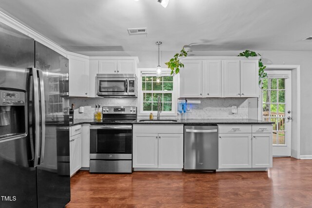 3803 Jonesville Rd, Wake Forest, NC 27587 - kitchen with appliances with stainless steel finishes, dark countertops, a sink, and backsplash