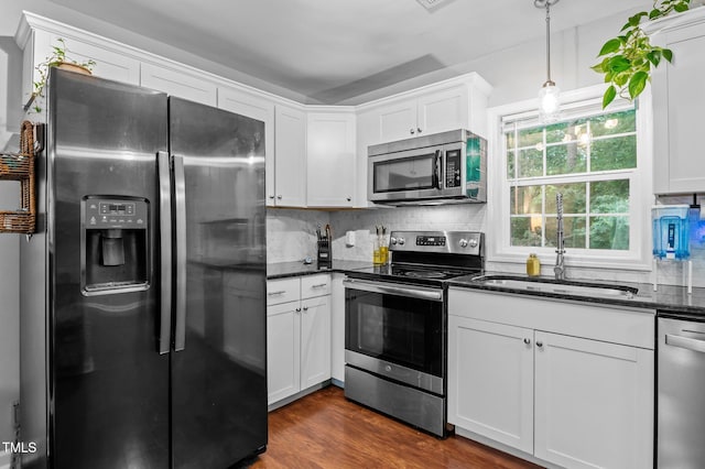 3803 Jonesville Rd, Wake Forest, NC 27587 - kitchen with appliances with stainless steel finishes, white cabinets, tasteful backsplash, dark stone counters, and a sink