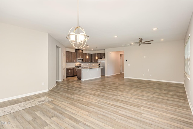 157 Willow Grove Ln, Fuquay Varina, NC 27526 - unfurnished living room with a sink, a chandelier, recessed lighting, baseboards, and light wood-type flooring
