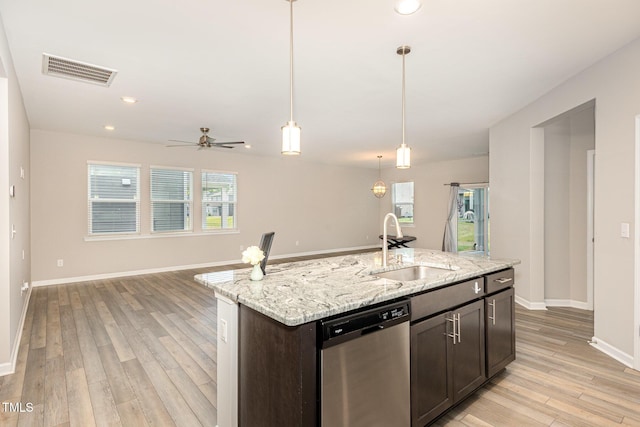 157 Willow Grove Ln, Fuquay Varina, NC 27526 - kitchen featuring stainless steel dishwasher, a sink, light wood-style flooring, open floor plan, and baseboards