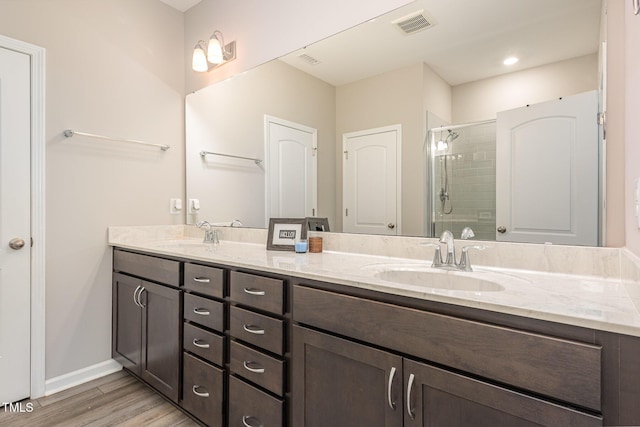 157 Willow Grove Ln, Fuquay Varina, NC 27526 - bathroom featuring double vanity, a shower stall, wood finished floors, and baseboards