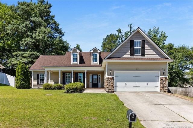 1517 Seabiscuit Dr, Parkton, NC 28371 - view of front of home featuring concrete driveway, covered porch, an attached garage, and stone siding