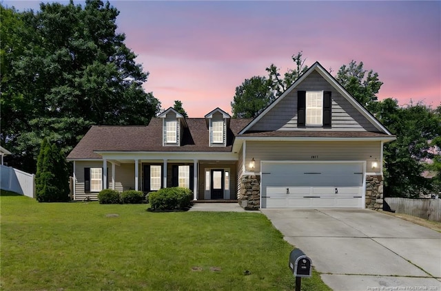 1517 Seabiscuit Dr, Parkton, NC 28371 - view of front of home featuring driveway, stone siding, a garage, and a porch