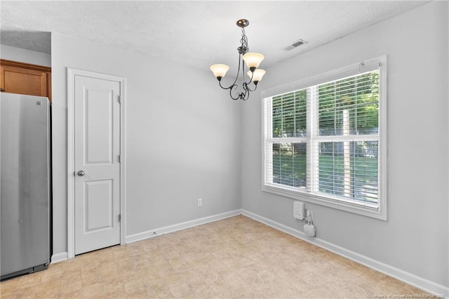 1517 Seabiscuit Dr, Parkton, NC 28371 - unfurnished room featuring a chandelier, baseboards, and a textured ceiling