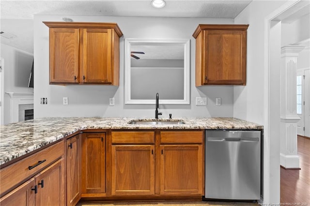 1517 Seabiscuit Dr, Parkton, NC 28371 - kitchen featuring dishwasher, a sink, light stone counters, brown cabinetry, and a ceiling fan