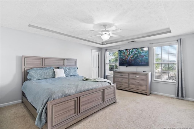 1517 Seabiscuit Dr, Parkton, NC 28371 - bedroom featuring a tray ceiling, a textured ceiling, baseboards, and light carpet