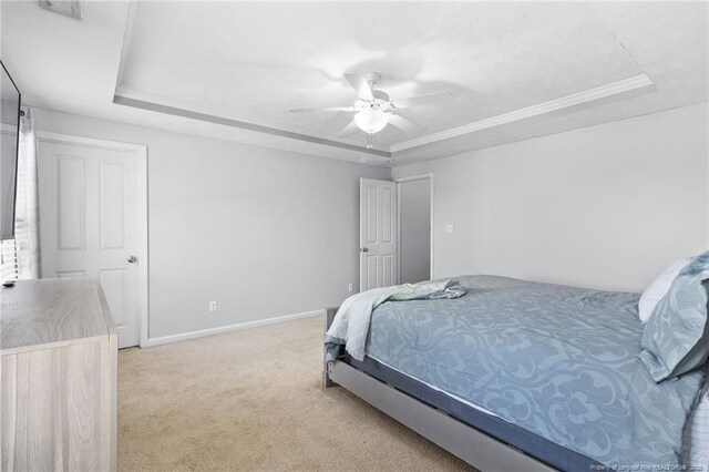 1517 Seabiscuit Dr, Parkton, NC 28371 - bedroom featuring a tray ceiling, light colored carpet, and baseboards