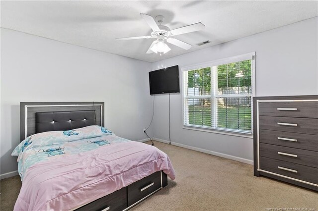 1517 Seabiscuit Dr, Parkton, NC 28371 - bedroom featuring light colored carpet, baseboards, and a ceiling fan