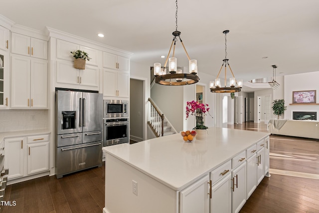 1475 Sierra Glen Cir, Apex, NC 27502 - kitchen with stainless steel appliances, recessed lighting, dark wood-type flooring, decorative backsplash, and white cabinetry