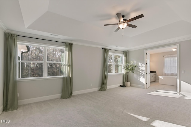 1475 Sierra Glen Cir, Apex, NC 27502 - carpeted spare room with a ceiling fan, plenty of natural light, a tray ceiling, and baseboards