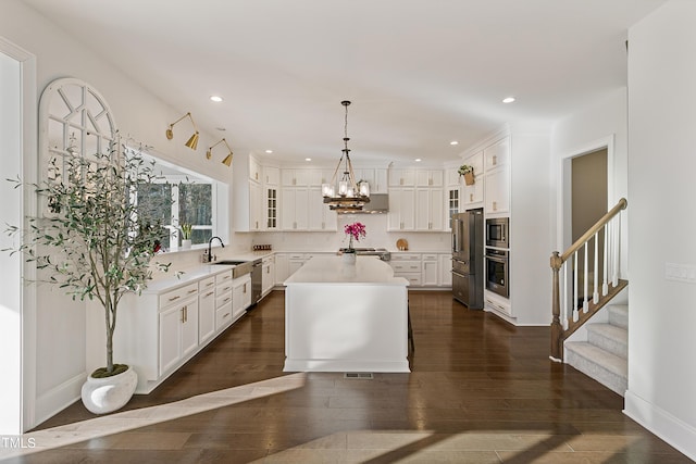 1475 Sierra Glen Cir, Apex, NC 27502 - kitchen with appliances with stainless steel finishes, a sink, light countertops, dark wood finished floors, and recessed lighting
