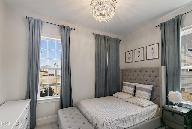 1475 Sierra Glen Cir, Apex, NC 27502 - bedroom featuring multiple windows, a chandelier, and baseboards