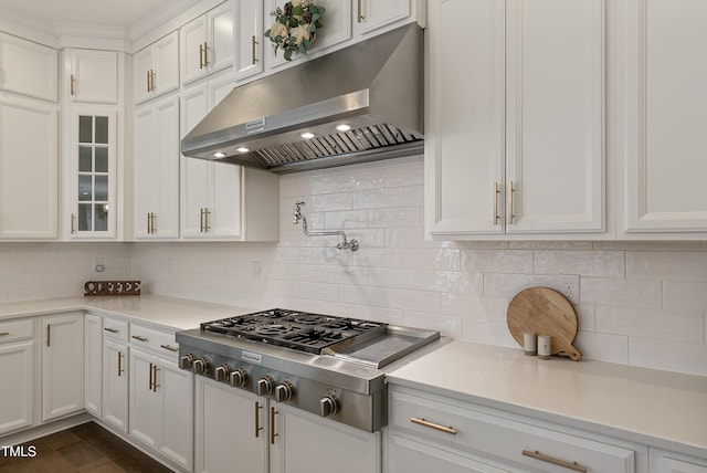1475 Sierra Glen Cir, Apex, NC 27502 - kitchen with under cabinet range hood, stainless steel gas cooktop, white cabinets, and light countertops