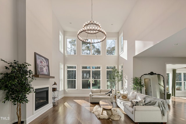 1475 Sierra Glen Cir, Apex, NC 27502 - living room featuring a chandelier, a high ceiling, hardwood / wood-style floors, and healthy amount of natural light